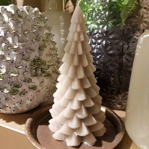 Een witte kaars in de vorm van een kerstboom